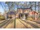 Brick house with a screened-in porch, a green door, and an empty backyard at 2501 Huntsman Trl, Zebulon, NC 27597