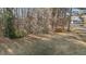 Manicured backyard with lush green grass and mature trees at 2501 Huntsman Trl, Zebulon, NC 27597