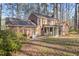Brick house with a screened-in porch, a green door, and a tree filled backyard at 2501 Huntsman Trl, Zebulon, NC 27597