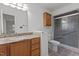 Bathroom showcasing granite countertop, wooden cabinetry, and glass-enclosed shower at 2501 Huntsman Trl, Zebulon, NC 27597