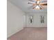 Bedroom featuring neutral carpet, a ceiling fan, and two windows with natural light at 2501 Huntsman Trl, Zebulon, NC 27597