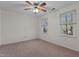 Bedroom featuring neutral carpet, a ceiling fan, and two windows with natural light at 2501 Huntsman Trl, Zebulon, NC 27597