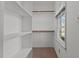 Spacious walk-in closet with built-in shelving and natural light from the window at 2501 Huntsman Trl, Zebulon, NC 27597