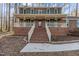 Charming brick home featuring a welcoming front porch and grand brick staircase leading to the entrance at 2501 Huntsman Trl, Zebulon, NC 27597