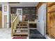 A closer view of the garage with a lift, wooden stairs and an access door at 2501 Huntsman Trl, Zebulon, NC 27597