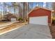 Home featuring a red garage with white door and long driveway at 2501 Huntsman Trl, Zebulon, NC 27597