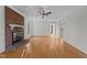 Spacious living room with hardwood floors, a brick fireplace, and bright, natural lighting at 2501 Huntsman Trl, Zebulon, NC 27597
