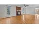 Spacious living room with hardwood floors, a brick fireplace, and bright, natural lighting at 2501 Huntsman Trl, Zebulon, NC 27597