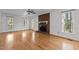 Bright living room features hardwood flooring, a fireplace, and numerous windows for natural light at 2501 Huntsman Trl, Zebulon, NC 27597