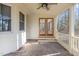 Screened-in porch with ceiling fan and views of the wooded backyard at 2501 Huntsman Trl, Zebulon, NC 27597
