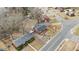 Aerial view of a home's landscaped yard, driveway, detached garage and neighborhood street at 2503 Mckinney St, Burlington, NC 27217