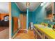 Retro bathroom with blue walls, yellow countertops, and a glass-enclosed shower offers functionality at 2503 Mckinney St, Burlington, NC 27217