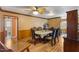 An open-concept dining room features hard wood floors, a ceiling fan, and a set dining room table at 2503 Mckinney St, Burlington, NC 27217