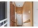 A home's entryway with a brick wall, white door, and light fixture provides a welcoming entrance at 2503 Mckinney St, Burlington, NC 27217