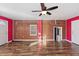 Living room features hardwood floors, exposed brick and a ceiling fan at 2503 Mckinney St, Burlington, NC 27217