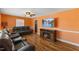 Comfortable living room featuring hardwood floors, a ceiling fan, and a wall-mounted television at 2503 Mckinney St, Burlington, NC 27217