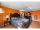 This main bedroom features hard wood floors, a ceiling fan, and a queen bed. It feels bright and airy at 2503 Mckinney St, Burlington, NC 27217
