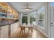 Bright dining area with a ceiling fan, hardwood floors, and a bay window providing natural light at 2504 Wertherson Ln, Raleigh, NC 27613