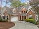 A beautiful brick home boasts a two-car garage and a circular driveway at 2504 Wertherson Ln, Raleigh, NC 27613