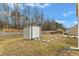 A backyard shed offers additional storage space in this yard, complemented by a stone pathway and bordering trees at 2728 Spring Valley Dr, Creedmoor, NC 27522