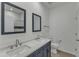 A stunning bathroom shows a double sink vanity with framed mirrors and luxury fixtures with stylish wall tiling at 2728 Spring Valley Dr, Creedmoor, NC 27522