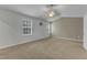 Spacious bedroom featuring neutral tones, plush carpeting, and ample natural light from dual windows at 2728 Spring Valley Dr, Creedmoor, NC 27522