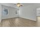 Empty bedroom with light wood-look flooring, two windows and a ceiling fan at 2728 Spring Valley Dr, Creedmoor, NC 27522