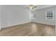 Spacious bedroom with light wood-look flooring and multiple windows providing lots of natural light at 2728 Spring Valley Dr, Creedmoor, NC 27522
