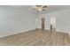 Large bedroom with ensuite bathroom and walk-in closet featuring light wood-look flooring and a ceiling fan at 2728 Spring Valley Dr, Creedmoor, NC 27522