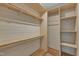 The walk-in closet features custom wood shelving and provides ample storage solutions for an organized lifestyle at 2728 Spring Valley Dr, Creedmoor, NC 27522