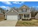 Charming two-story home with a two-car garage, manicured lawn, and inviting front porch at 2728 Spring Valley Dr, Creedmoor, NC 27522