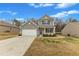 Two-story home with a two-car garage, tidy landscaping, and a welcoming front porch at 2728 Spring Valley Dr, Creedmoor, NC 27522
