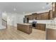 Bright, modern kitchen with stainless appliances, granite countertops, wood cabinets, and an island with seating at 2728 Spring Valley Dr, Creedmoor, NC 27522