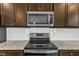 New kitchen features stainless steel appliances, granite countertops, and white subway tile backsplash at 2728 Spring Valley Dr, Creedmoor, NC 27522