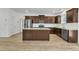 Modern kitchen features stainless steel appliances, granite countertops, wood cabinets, and a kitchen island at 2728 Spring Valley Dr, Creedmoor, NC 27522