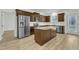 Stylish kitchen featuring stainless steel appliances, a center island, and dark wood cabinetry at 2728 Spring Valley Dr, Creedmoor, NC 27522