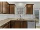 Kitchen sink with granite countertops, stainless steel dishwasher and wooden cabinets at 2728 Spring Valley Dr, Creedmoor, NC 27522