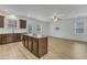 Open-concept kitchen and dining area, featuring a kitchen island with granite countertops and wood cabinets at 2728 Spring Valley Dr, Creedmoor, NC 27522