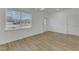 Inviting living room with hardwood floors, large window, and storm door at 2728 Spring Valley Dr, Creedmoor, NC 27522