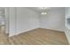 Minimalist living room with hardwood floors, white walls, and natural light at 2728 Spring Valley Dr, Creedmoor, NC 27522