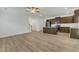 Open-concept living space with modern kitchen, adjacent to the staircase, featuring light wood floors at 2728 Spring Valley Dr, Creedmoor, NC 27522