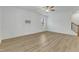 Open living area with light wood floors, a ceiling fan, and a staircase leading to upper level at 2728 Spring Valley Dr, Creedmoor, NC 27522