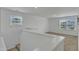 Upstairs loft area featuring neutral carpet, staircase and two large windows provides a blank canvas for your style at 2728 Spring Valley Dr, Creedmoor, NC 27522
