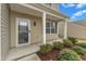 Inviting front porch with white columns, a storm door, and manicured landscaping at 2728 Spring Valley Dr, Creedmoor, NC 27522