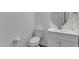 Cozy powder room with modern fixtures, including a round mirror and vanity at 2728 Spring Valley Dr, Creedmoor, NC 27522