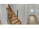 Carpeted staircase with wooden banister leading to the upper level, adjacent to the entryway at 2728 Spring Valley Dr, Creedmoor, NC 27522