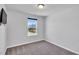 Bedroom features a large window overlooking a backyard, a TV mount, and carpeted flooring at 286 Beacon Hill Rd, Lillington, NC 27546