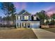 A beautiful two-story home with a combination of siding and brick, with well-manicured landscaping and driveway at 286 Beacon Hill Rd, Lillington, NC 27546