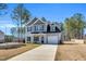 Charming two-story home features a gray exterior, black shutters, attached garage and a well-manicured front lawn at 286 Beacon Hill Rd, Lillington, NC 27546