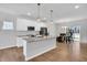 Modern kitchen with stainless steel appliances, granite countertops, a breakfast bar, and hardwood floors at 286 Beacon Hill Rd, Lillington, NC 27546